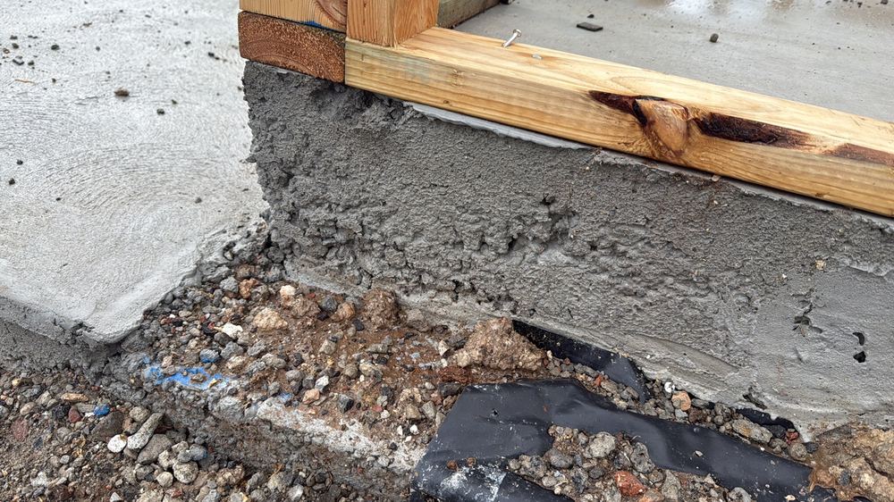 Honeycombed concrete along the slab edge, open voids that weaken it and let water in, Werribee