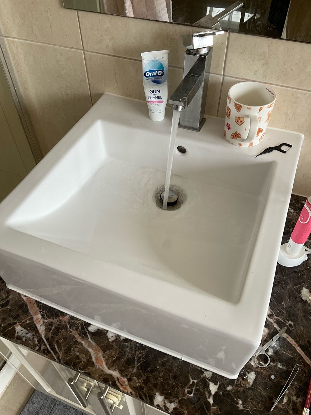 Basin draining slowly, a sign of a restriction in the waste, found during a pre-purchase inspection in Sunshine North