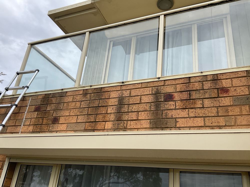 Water staining down brickwork below a flashing, found during a pre-purchase inspection in Sunshine North